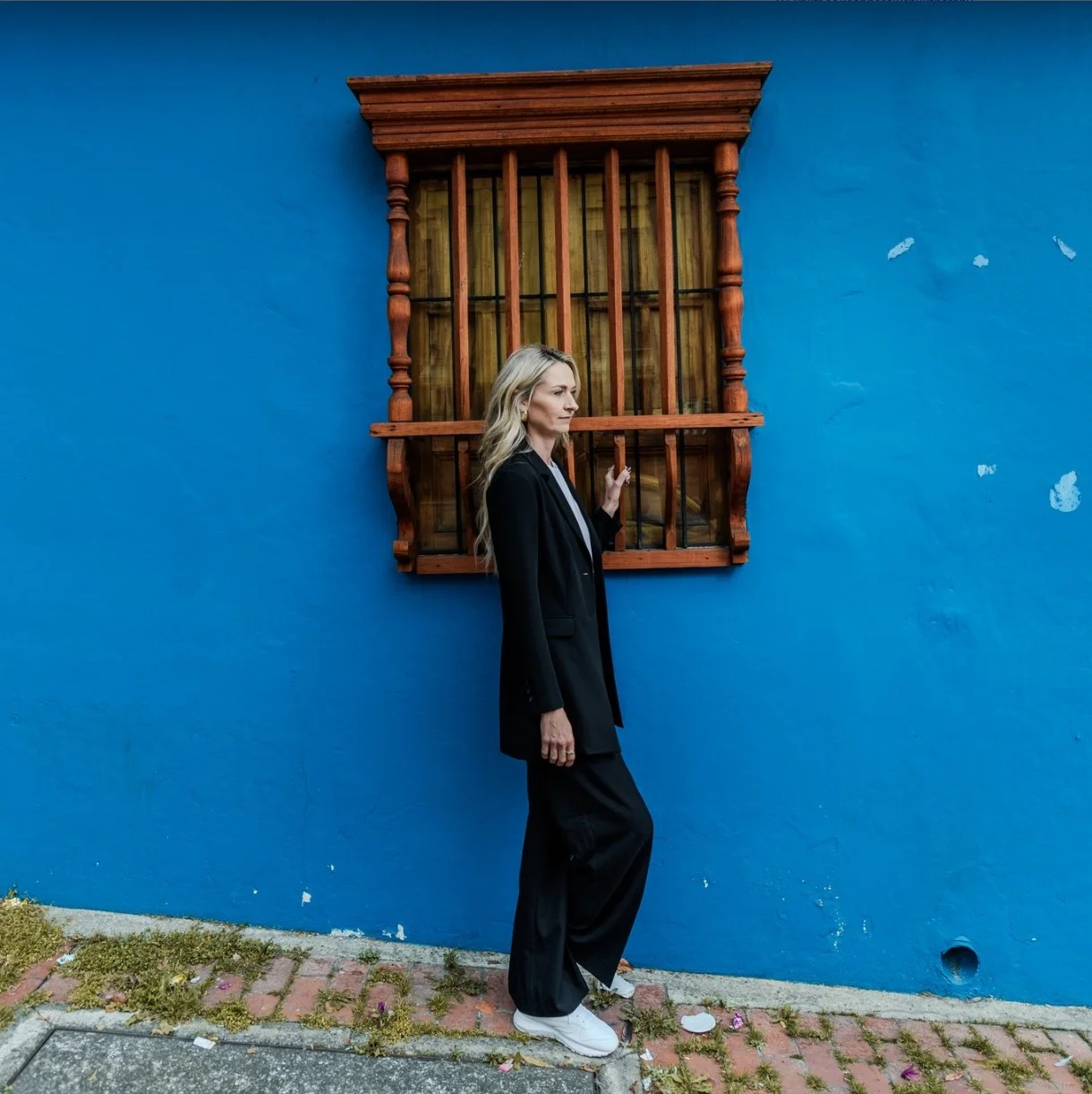 Leanne Sawchuk, psychotherapist in Waterloo, sitting in a warm, softly lit therapeutic space.